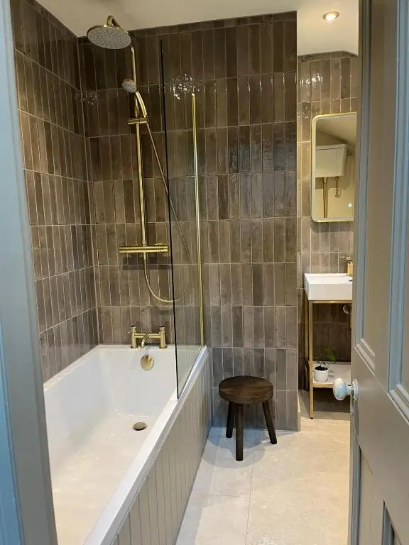 a bathroom with a tub and a shower and a sink at Lewis Lodge - Stunning & Exclusive Luxury Home in the Heart of Ballater, Royal Deeside in Ballater