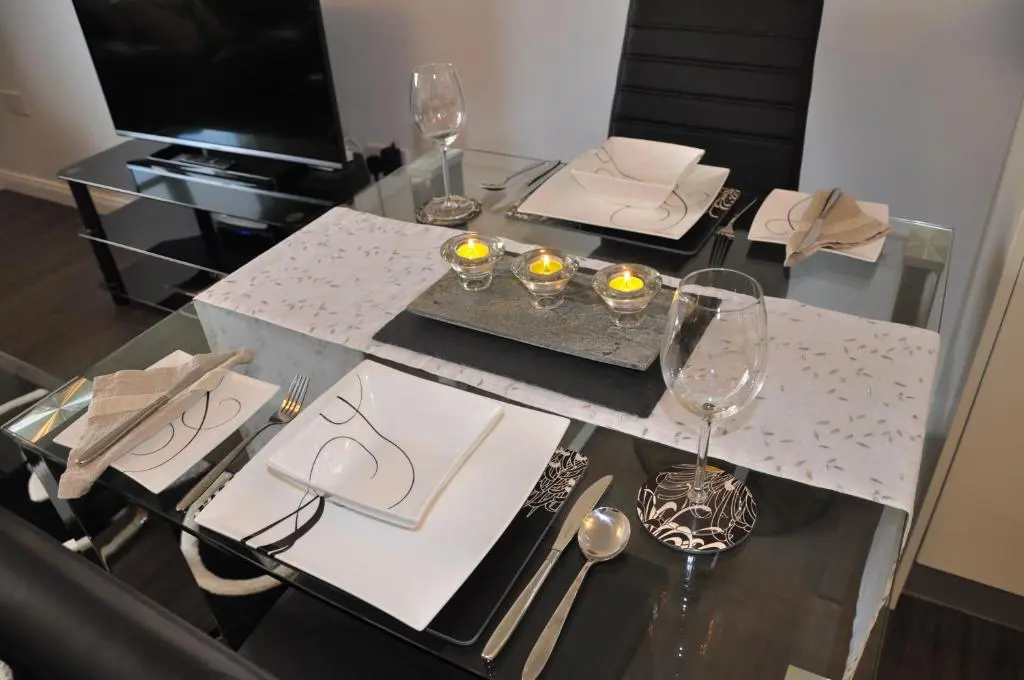 a dining room table with glasses and a table with at Westgate Apartments Birchlee in Inverurie