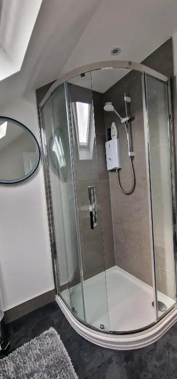 a shower with a glass enclosure in a bathroom at The Flat at Clocktower Buildings in Kinloss