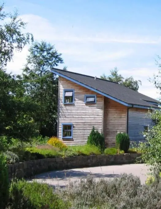 a house with two windows on the side of it at Findhorn Bay - Sandpiper Eco chalet in Findhorn