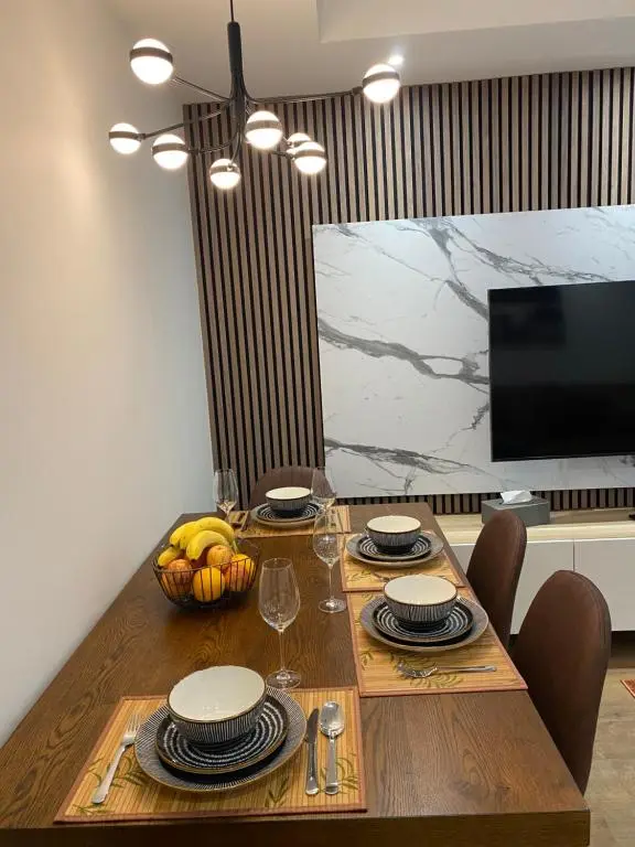 a dining room table with a bowl of fruit on it at 23 Innes Street Apartment in Inverness