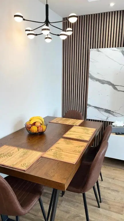 a wooden table with a bowl of bananas on it at 23 Innes Street Apartment in Inverness