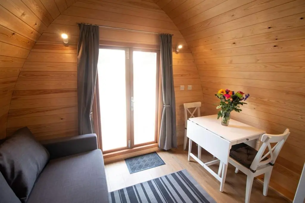 a small room with a table and a window at Findhorn Ecovillage Escape Eco Pod Pet free in Findhorn
