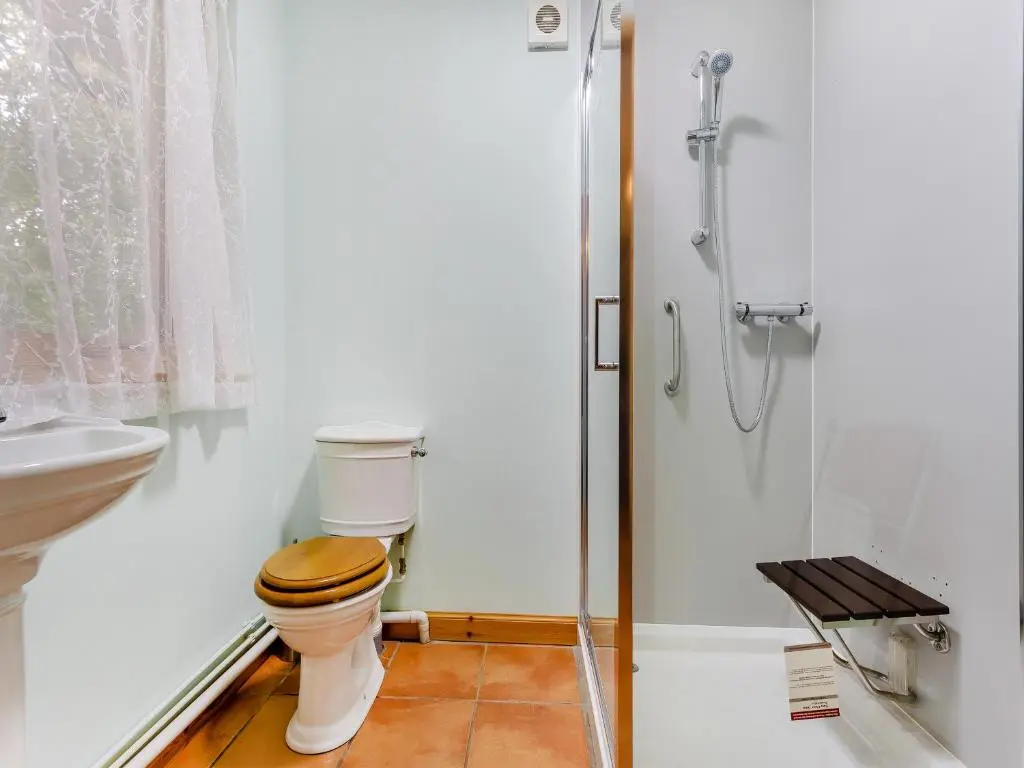 a bathroom with a toilet and a shower at Bridge House in Evanton