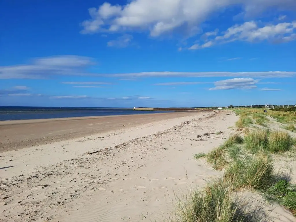 a sandy beach with the ocean in the background at The Nairn House in Nairn