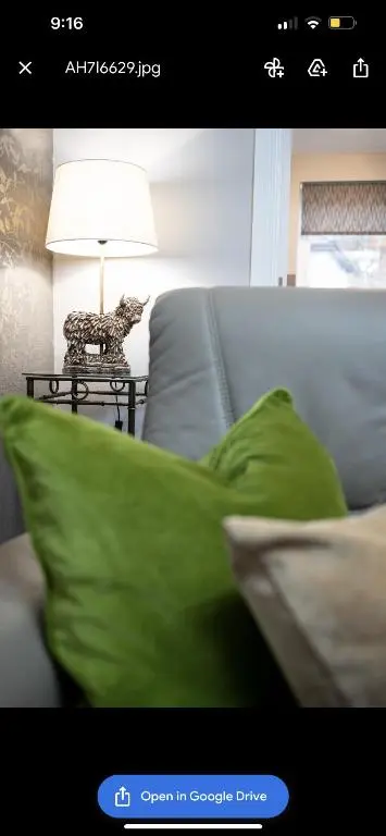 a picture of a living room with a couch with green pillows at Inverness Apartment - Uist in Inverness