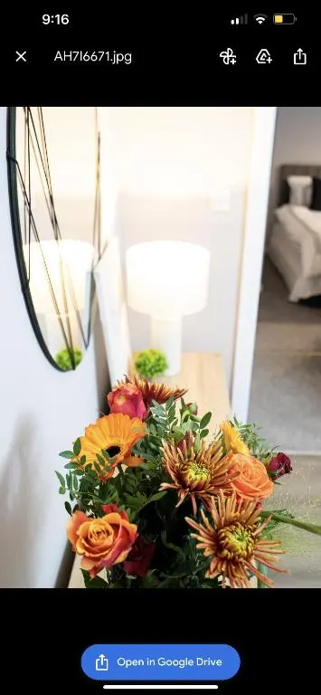 a picture of a bouquet of flowers on a table at Inverness Apartment - Uist in Inverness