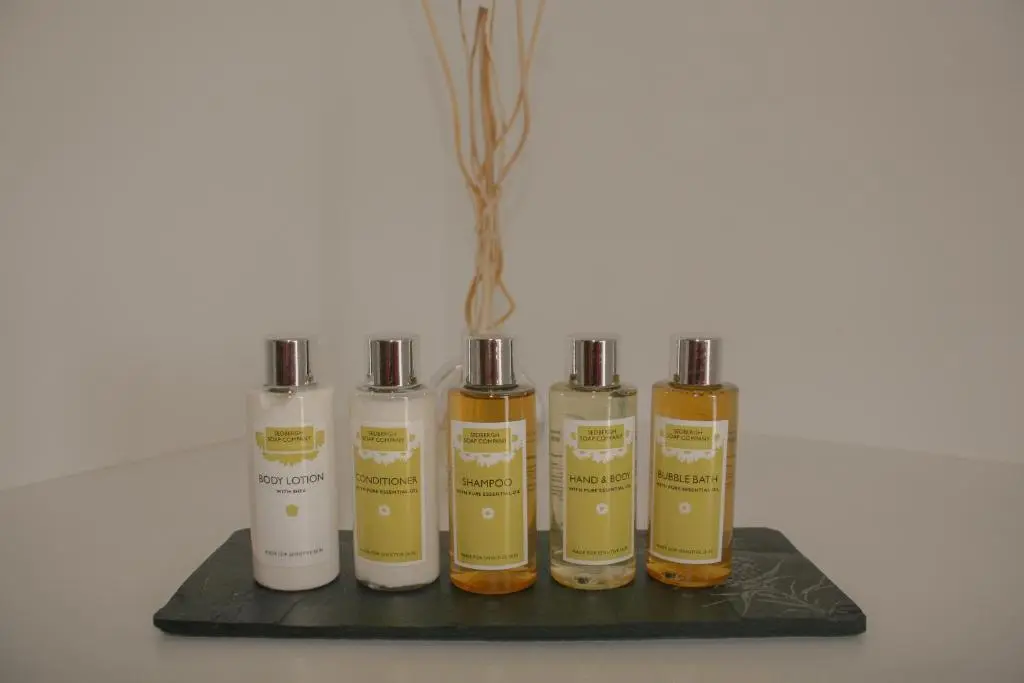 a group of four essential oils on a black tray at Loch Ness Gatehouse Apartments in Fort Augustus