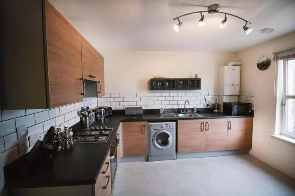 a kitchen with a washer and dryer in it at Inverurie Town Centre 97m2 Maisonette in Inverurie
