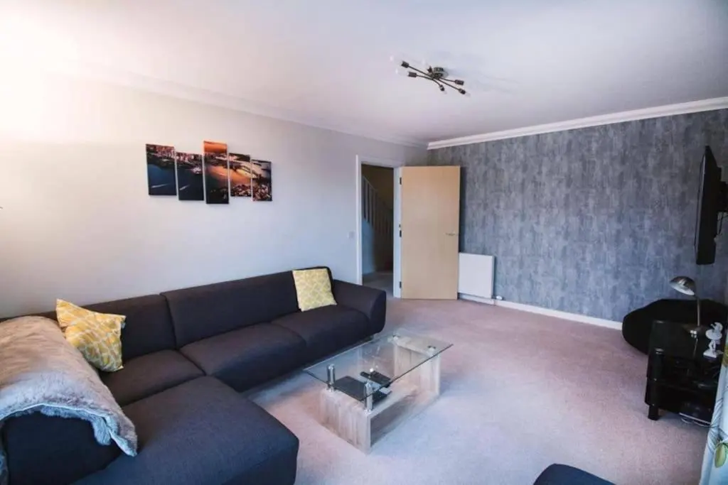 a living room with a couch and a table at Inverurie Town Centre 97m2 Maisonette in Inverurie