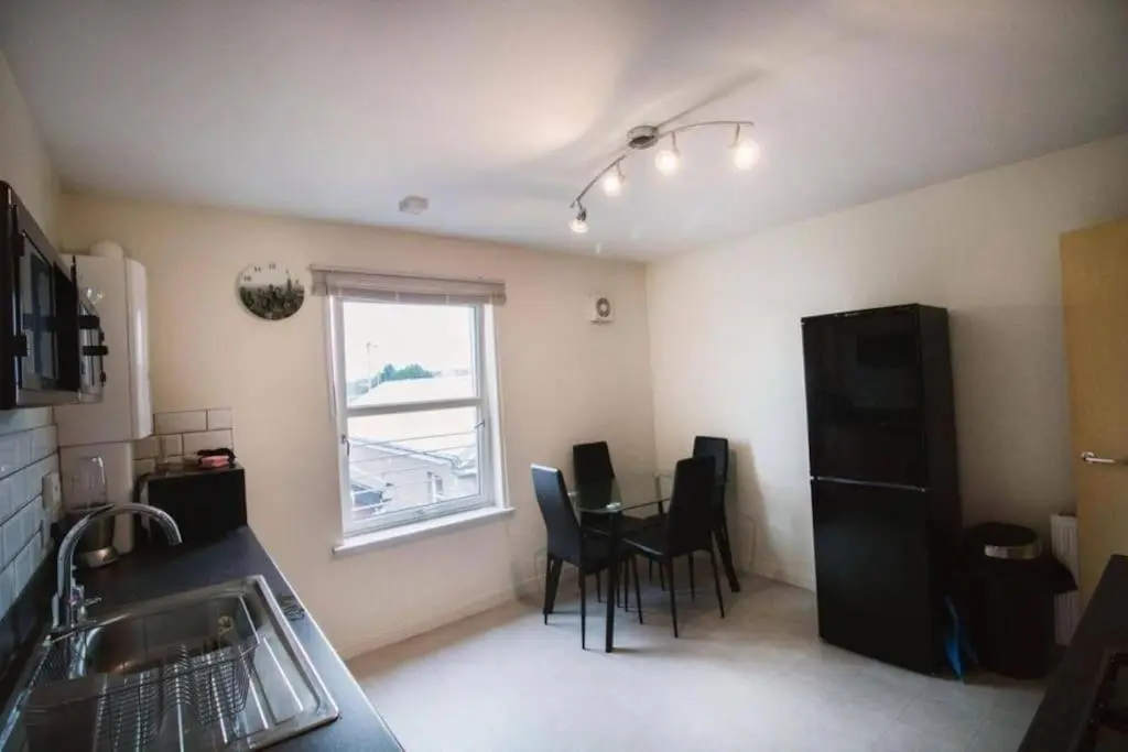 a kitchen with a table and chairs and a window at Inverurie Town Centre 97m2 Maisonette in Inverurie
