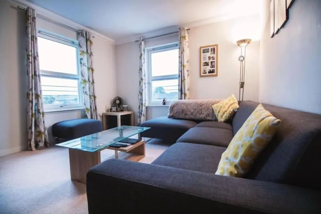 a living room with a couch and a glass table at Inverurie Town Centre 97m2 Maisonette in Inverurie