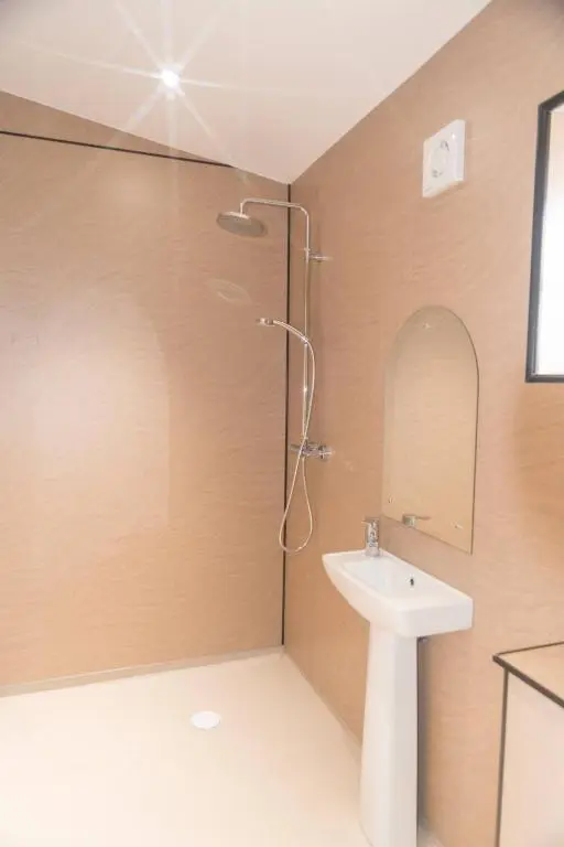 a bathroom with a shower and a sink at Cosy Spacious Highland Cottage in Craggie