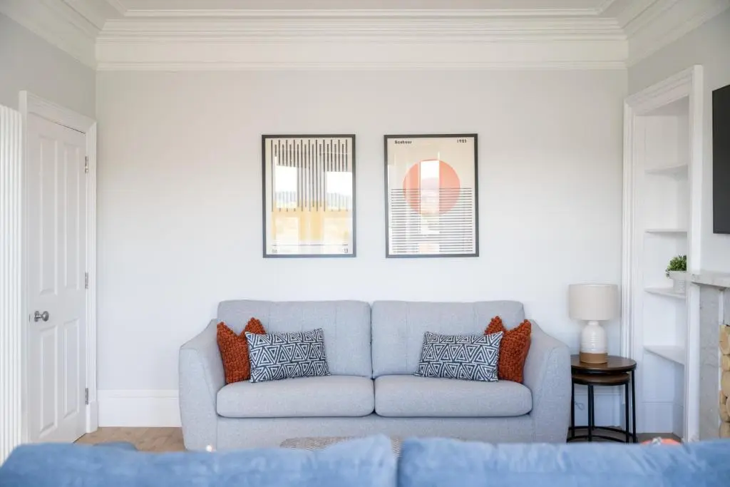a living room with a blue couch in a room at Hillside Luxury Apartments in Inverness