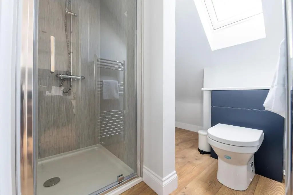 a bathroom with a toilet and a shower at Hillside Luxury Apartments in Inverness