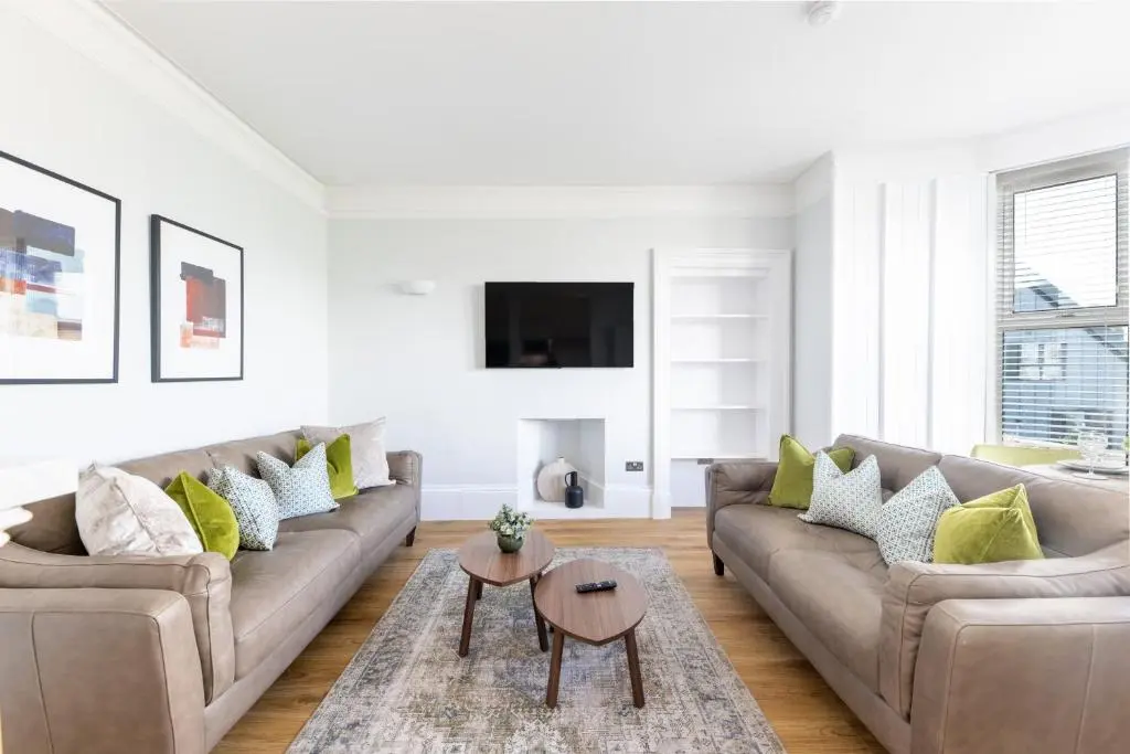 a living room with a couch and a table at Hillside Luxury Apartments in Inverness