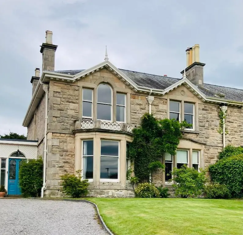 a large stone house with a driveway at Victorian Home in Moray in Forres
