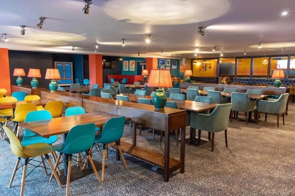 a waiting room with tables and chairs at Sea La Vie Caravan at Silver Sands Holiday Park in Lossiemouth