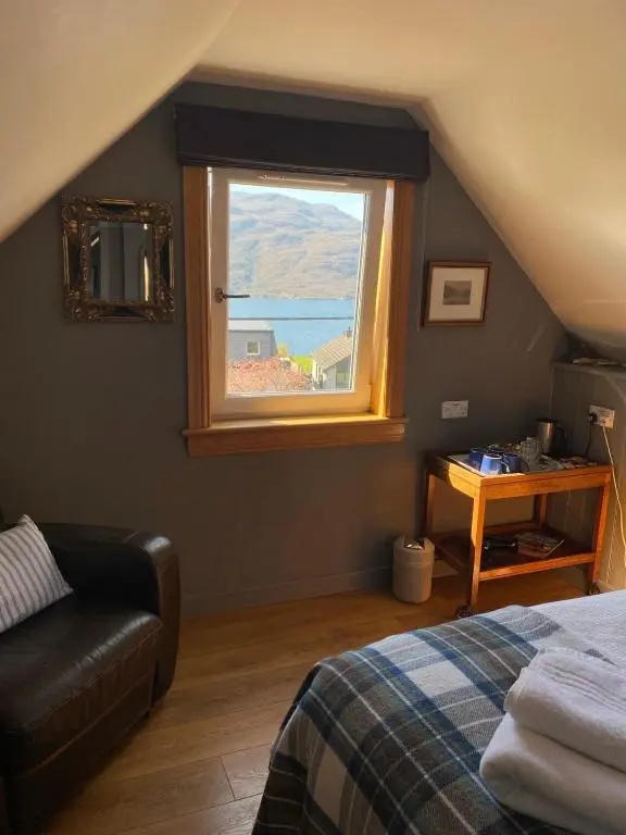 a bedroom with a bed and a window at Highland Rooms - Room Only No Breakfast in Ullapool