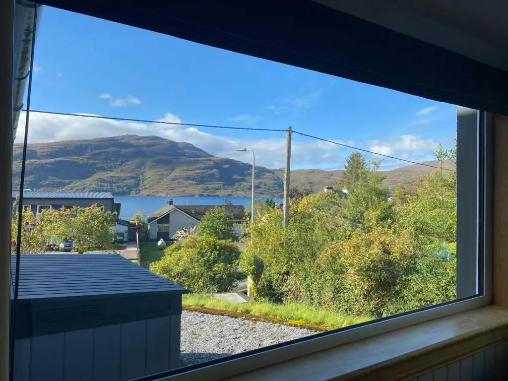 a view of a mountain from a window at Highland Rooms - Room Only No Breakfast in Ullapool