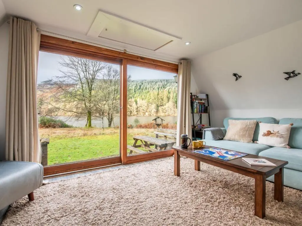 a living room with a couch and a table at Chalet Lodge 6 by Interhome in Spean Bridge