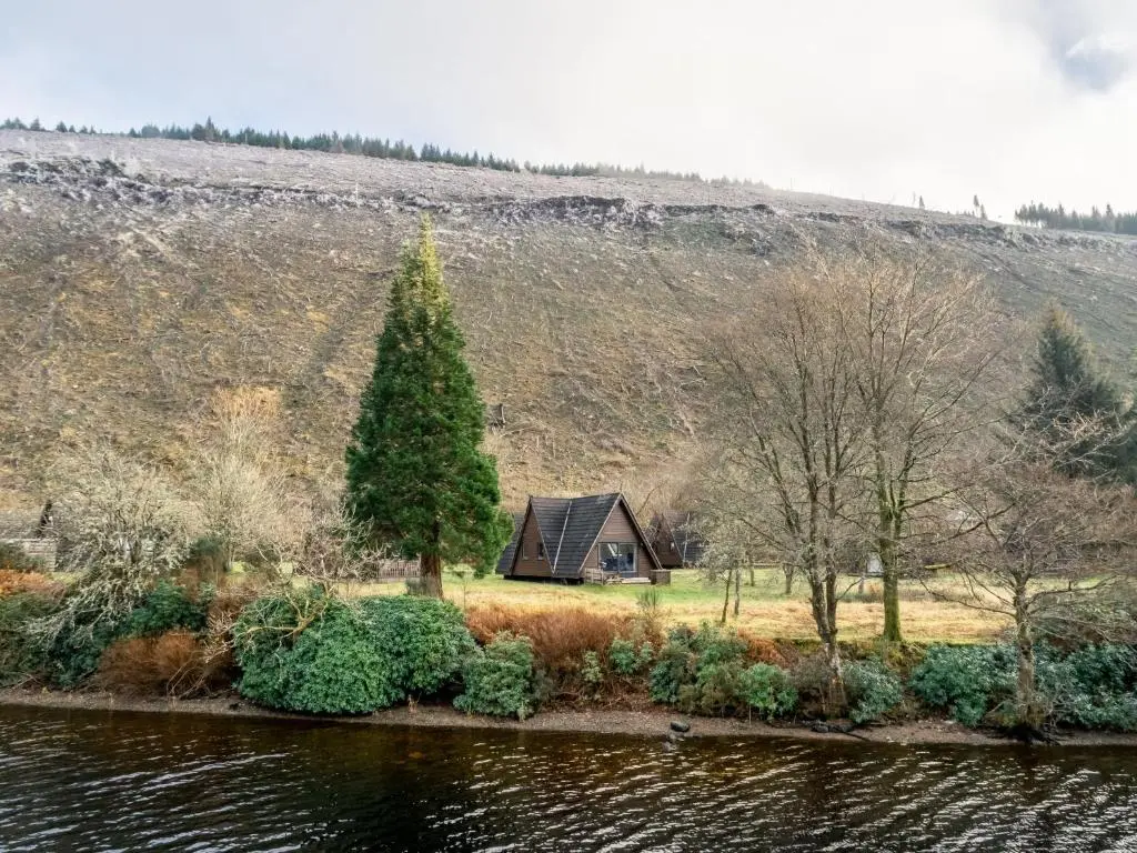 a house on the side of a hill next to a lake at Chalet Lodge 6 by Interhome in Spean Bridge