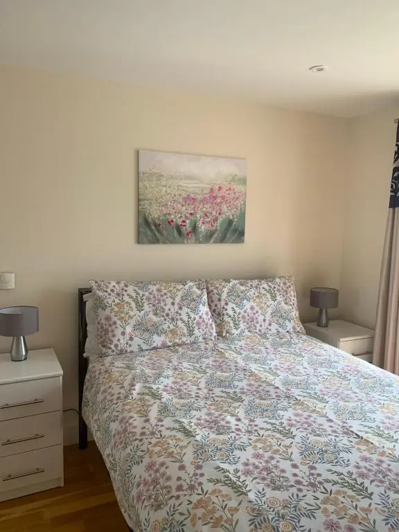 a bedroom with a bed and a painting on the wall at The Annexe in Lossiemouth