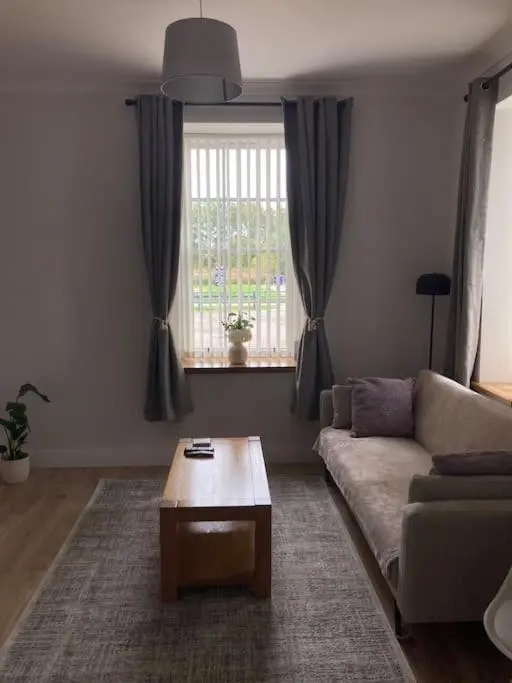 a living room with a couch and a coffee table at One bedroom Flat in Dingwall in Dingwall