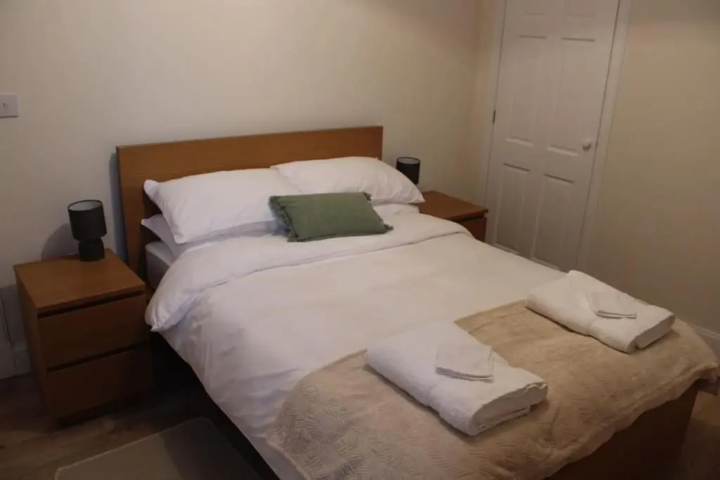 a bedroom with a large bed with towels on it at One bedroom Flat in Dingwall in Dingwall