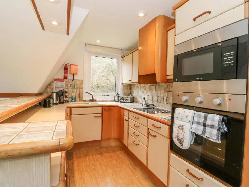 a kitchen with a sink and a stove top oven at Lodge 2 - Inglewood Lodge in Spean Bridge