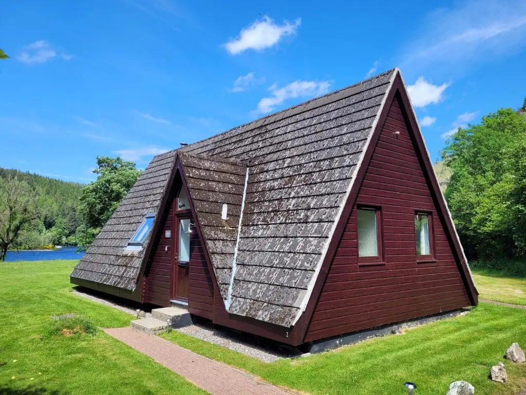 a small house with a gambrel roof at Lodge 2 - Inglewood Lodge in Spean Bridge
