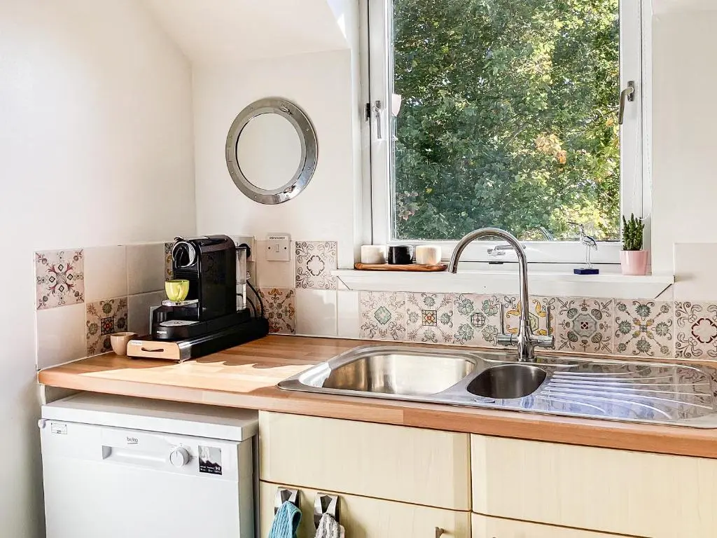 a kitchen counter with a sink and a window at Taigh Na Tunnagan in Nairn