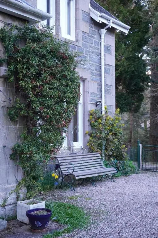a bench sitting in front of a building at Ardchoile in Kingussie