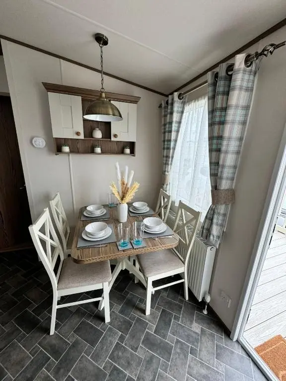 a dining room with a table and chairs at Jandor Retreat in Lossiemouth