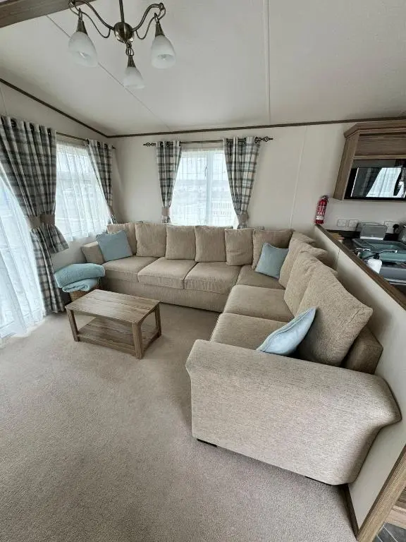 a living room with a couch and a table at Jandor Retreat in Lossiemouth