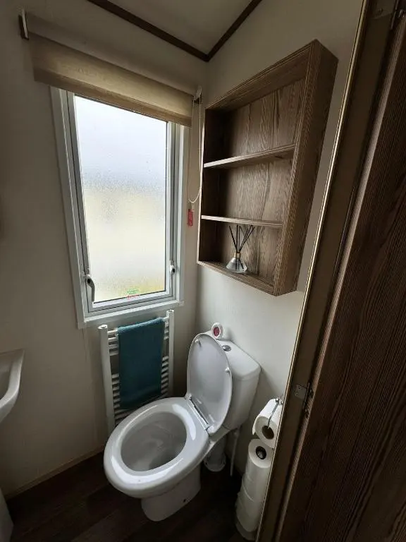 a small bathroom with a toilet and a window at Jandor Retreat in Lossiemouth