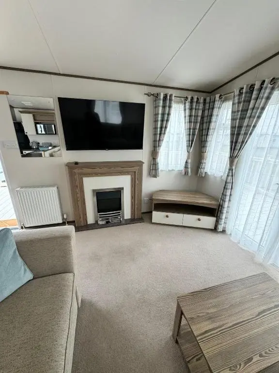 a living room with a couch and a tv at Jandor Retreat in Lossiemouth
