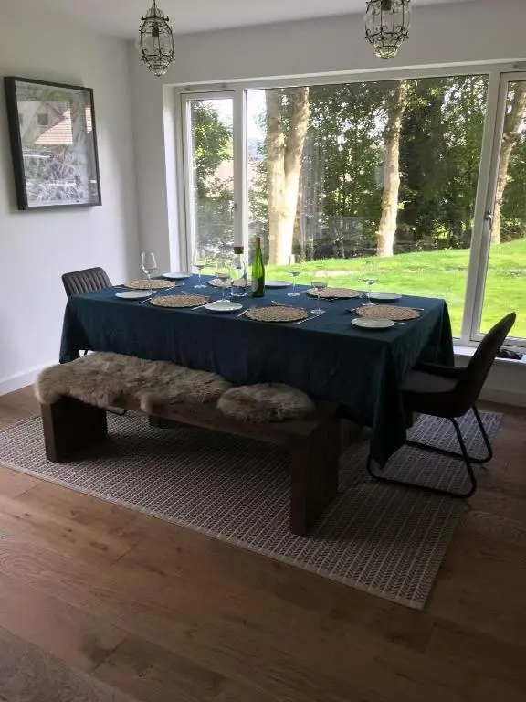 a dining room table with a blue table cloth on it at St Vincents in Kingussie