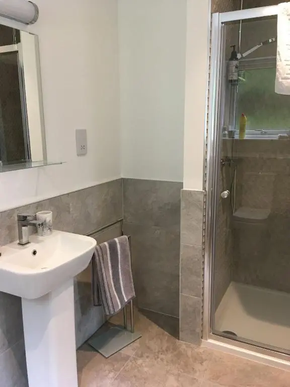 a bathroom with a sink and a shower at St Vincents in Kingussie
