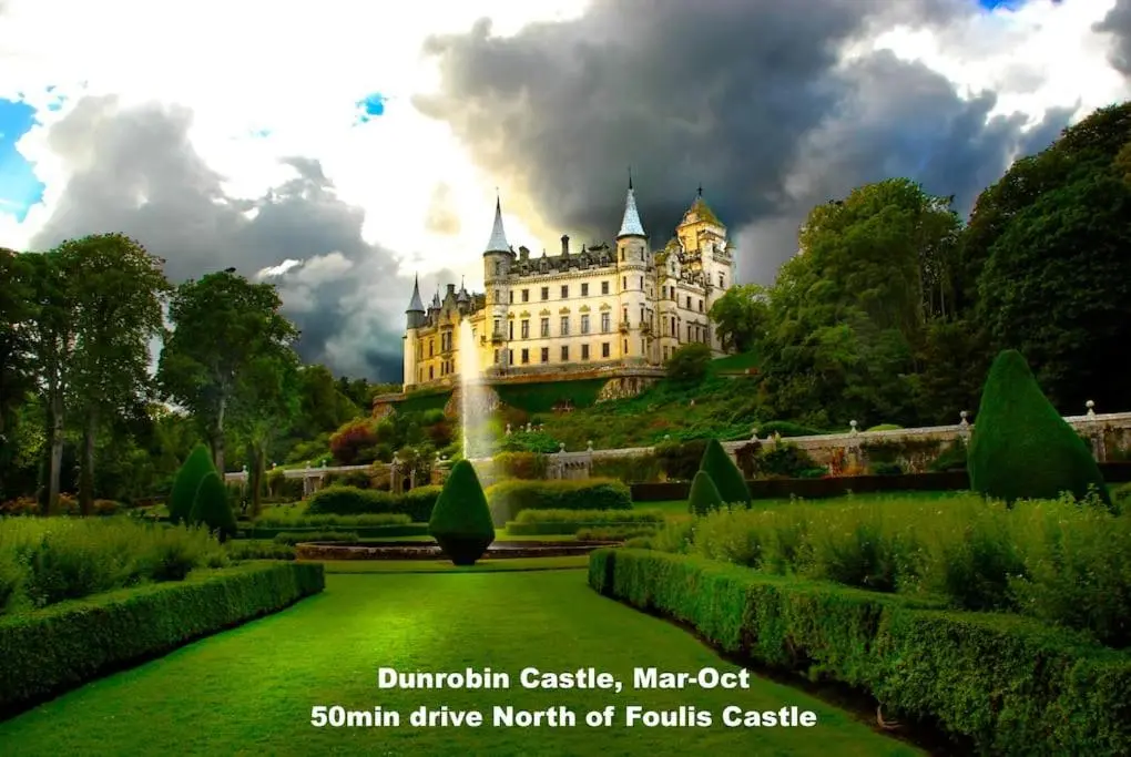 a castle on top of a hill with a garden at Foulis Cottage, Foulis Estate, Highland Scotland in Ardullie