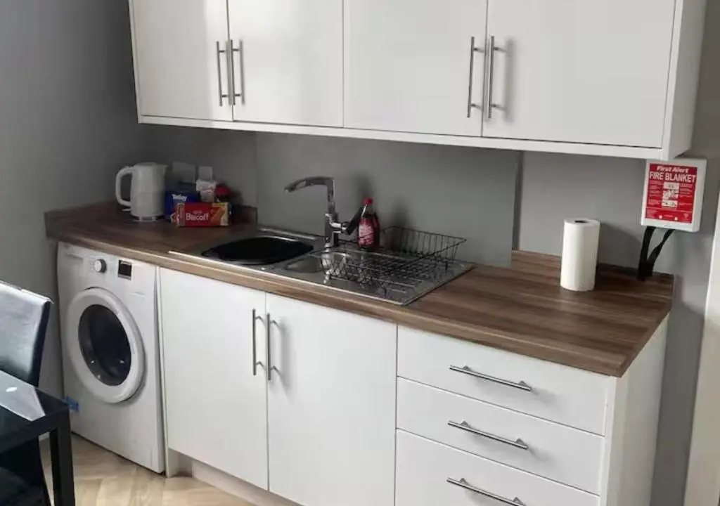 a kitchen with a sink and a washing machine at Frithside Retreat 3BR Sleeps 7 Coastal Getaway in Fraserburgh