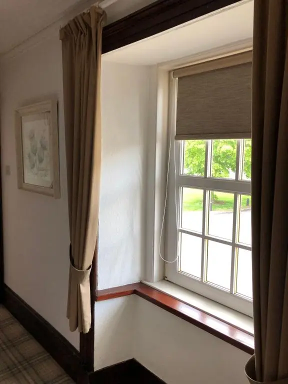 a window in a room with a window sill and a curtain at Haus Alba in Grantown on Spey