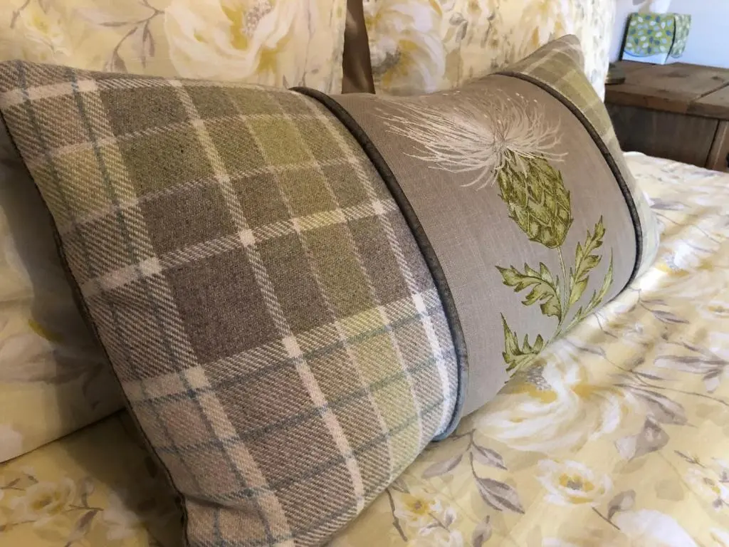 a pillow sitting on top of a bed at Haus Alba in Grantown on Spey