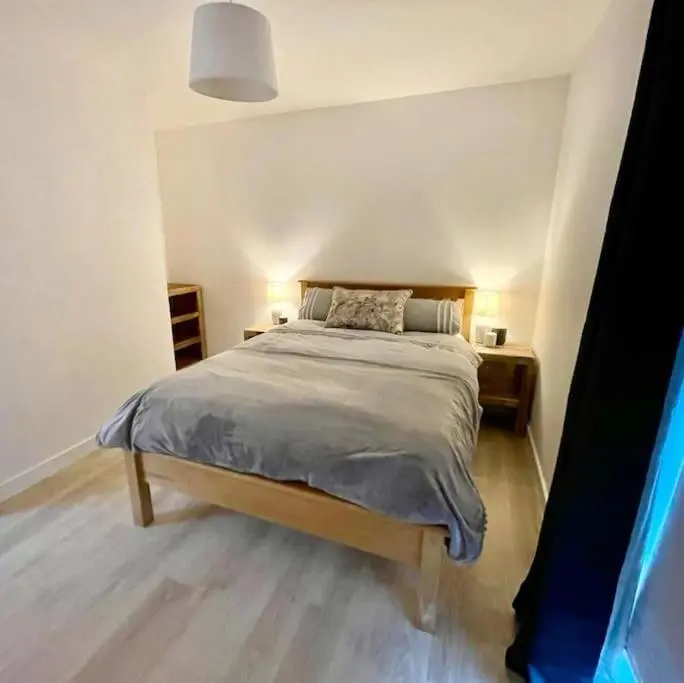 a bedroom with a large bed in a room at The Clearing in Huntly