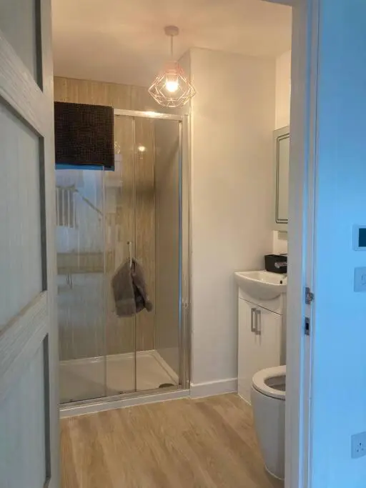 a bathroom with a shower and a toilet at The Clearing in Huntly