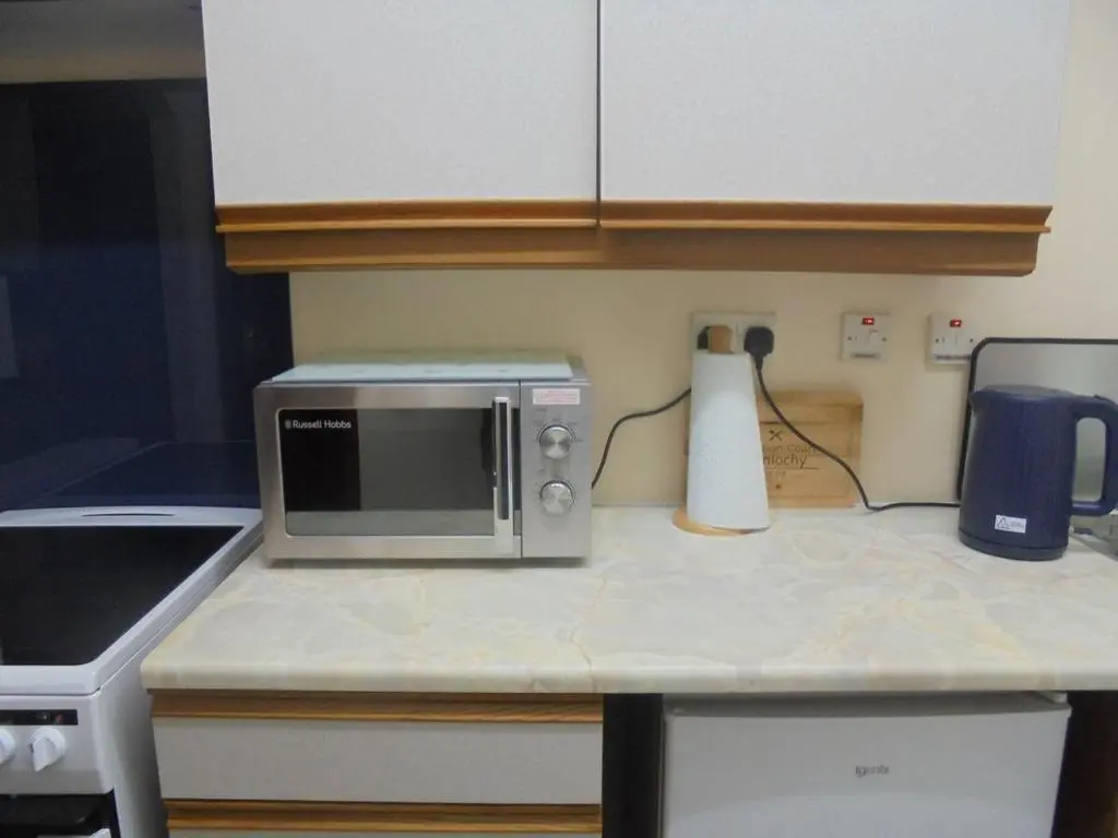 a microwave on a counter in a kitchen at 3 Station Court, Munlochy in Munlochy