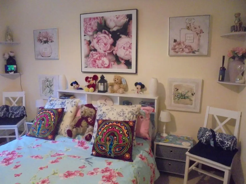 a bedroom with a bed with stuffed animals on it at 3 Station Court, Munlochy in Munlochy