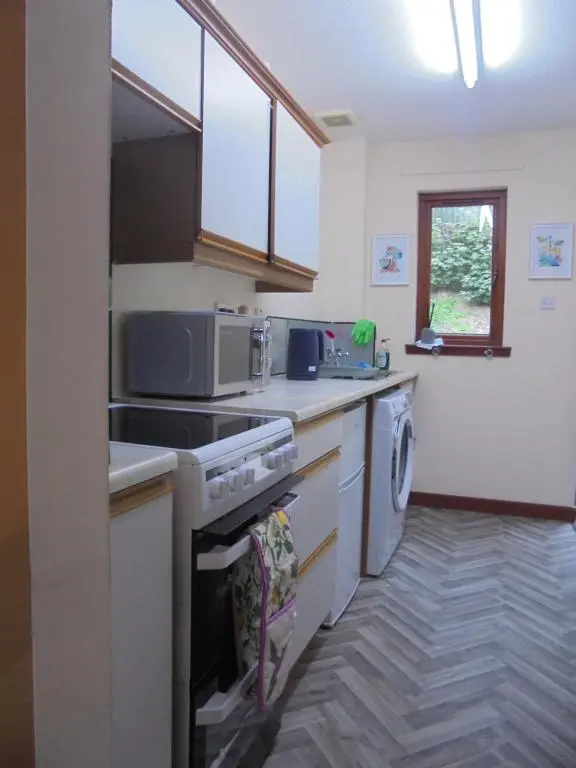 a kitchen with a sink and a stove top oven at 3 Station Court, Munlochy in Munlochy