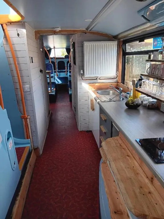 an interior view of a kitchen in an rv at Archie The Double Decker Bus in Tain