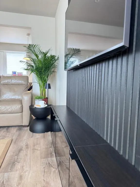 a living room with a black table and a couch at No 67 West Road in Fraserburgh